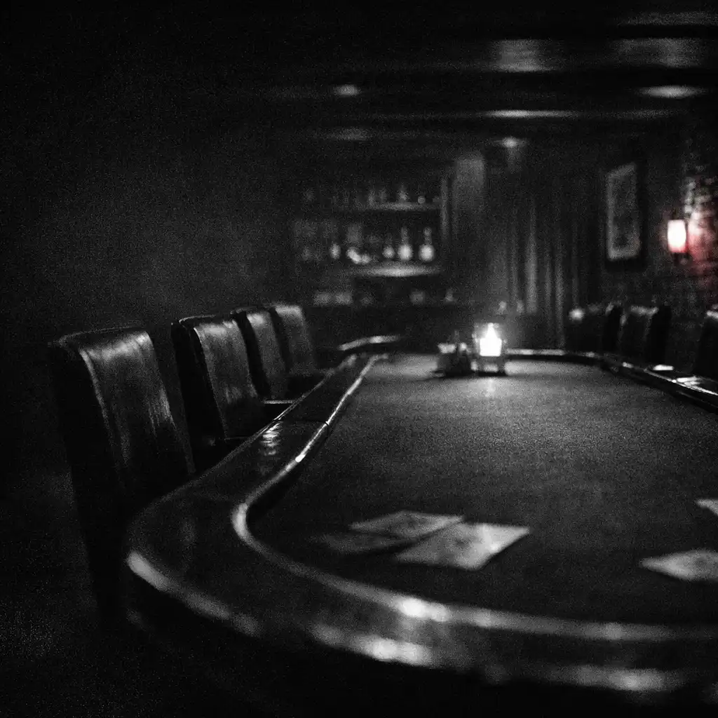 A secluded Chance and Hearth card room with a long poker table receding into shadow.